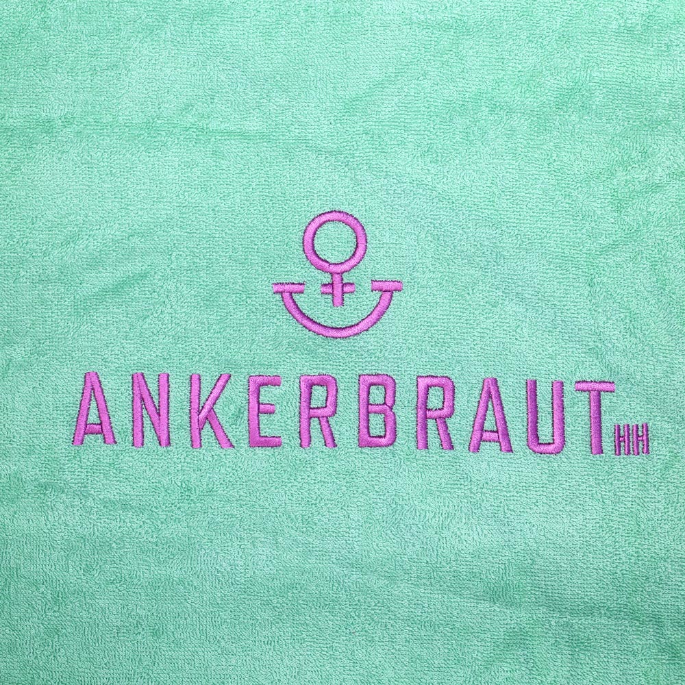 Weibliches Model mit ANKERBRAUT Beach-Poncho in Green
